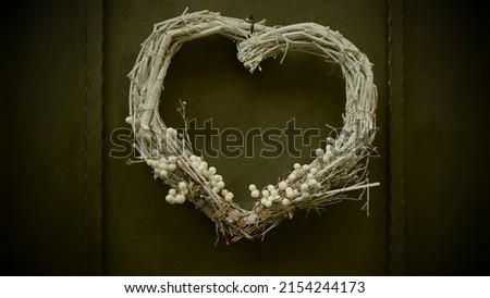 Decorative Christmas heart shaped wreath with frosted mistletoe leaves