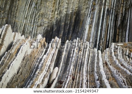 Famous flysch of Zumaia, Basque Country, Spain. Flysch is a sequence of sedimentary rock layers that progress from deep-water Royalty-Free Stock Photo #2154249347