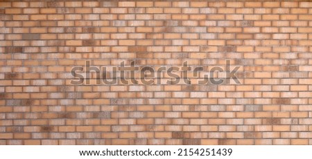 Dark brick wall pattern with chaotic masonry order. Background texture or resource for 3d texturing. Many bricks in big modern stone wall in full frame.