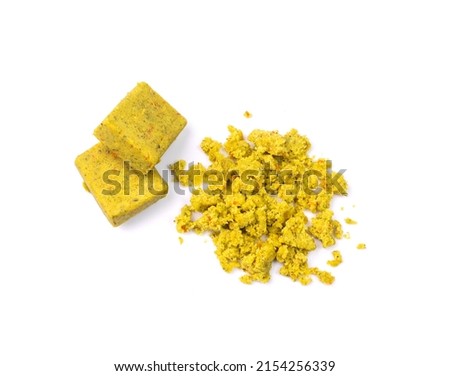 Stock cube isolated. Crumbled vegetable stock concentrat, , broken broth cubes, bouillon cube, instant spice soup ingredient on white background top view