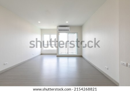 Bright empty interior with two large window, city view and blank gray wall.
