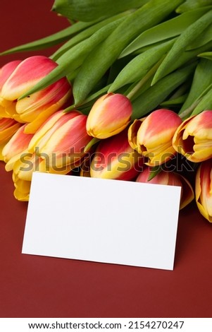 Clean minimal business card mockup with bouquet of tulips
