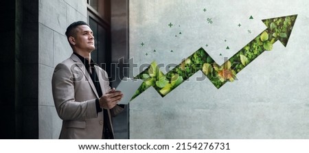 ESG Concepts. Environmental, Social and Corporate Governance. Businessman Working on Tablet. Sustainable Resources. Environmental and Business Growth Together. Blurred Green Leaf Arrow as background Royalty-Free Stock Photo #2154276731