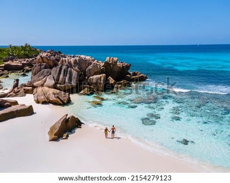 Anse Cocos beach, La Digue Island, Seyshelles, Drone aerial view of La Digue Seychelles bird eye view.of tropical Island, couple men and woman walking at the beach during sunset at a luxury vacation Royalty-Free Stock Photo #2154279123