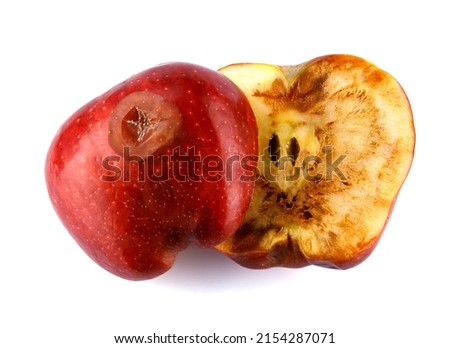 Halved rotten apple is isolated against a white background. Full clipping path. The red apple is spoiled Royalty-Free Stock Photo #2154287071
