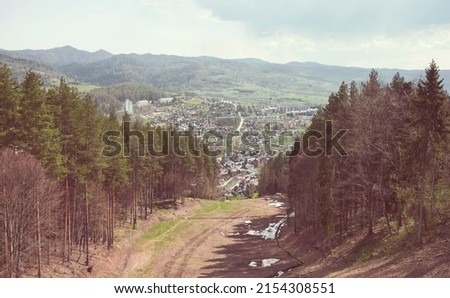 Retro toned picture of Pienin Mountains with town of Szczawnica in distance, Poland.