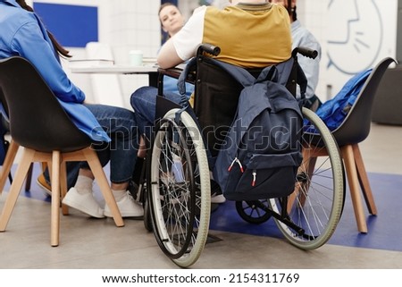 Back view at young college student in wheelchair participating in group discussion, copy space Royalty-Free Stock Photo #2154311769