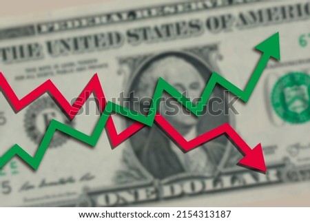 Blurred one US dollar bill with green stock market chart arrow going up and red arrow going down. Dollar exchange rate going both up and down concept. Royalty-Free Stock Photo #2154313187