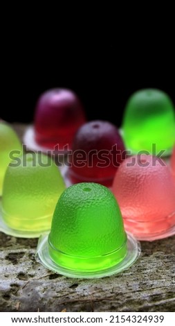 Colorful jelly in plastic bowls, Jam in plastic with raw fruit, Packaged, colorful, for small children's food, soft like pudding, factory made, inaco, collection, candy, gummy, kids food, neat.