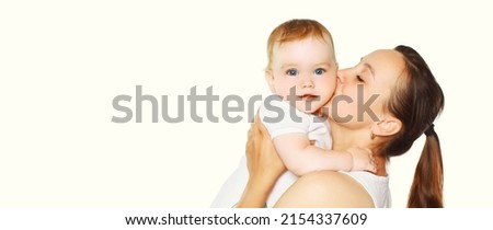 Portrait of happy mother holding and kissing her cute baby on white background, blank copy space for advertising text