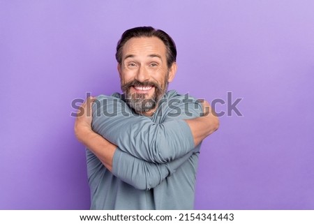 Portrait of handsome cheerful lovely man hug embrace his shoulders self care isolated on purple color background Royalty-Free Stock Photo #2154341443