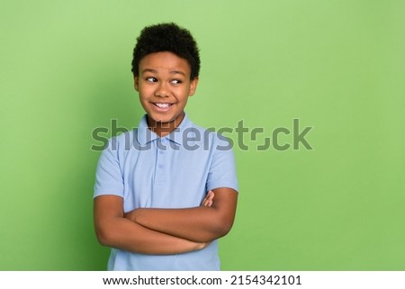 Portrait of attractive cheerful pre-teen pupil schoolkid folded arms lesson copy space isolated over green color background Royalty-Free Stock Photo #2154342101