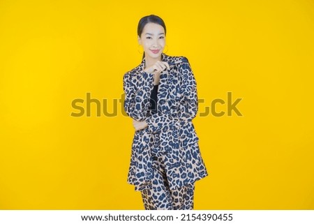 Portrait beautiful young asian woman with make up brush cosmetic on color background