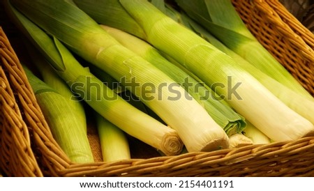 Close-up of many beautiful leeks in a wicker basket