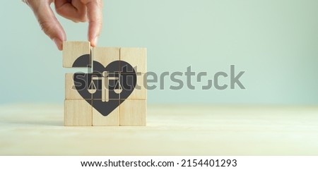 Ethical corporate culture concept. Ethics inside human heart. Business integrity and moral. Placing wooden cubes with ethics inside a heart on smart background. Sustainable business development. Royalty-Free Stock Photo #2154401293