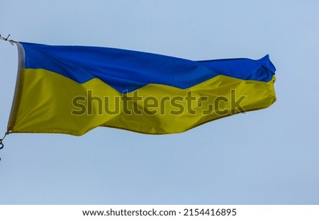 Ukrainian flag on the blue background.  A modern symbol of courage and freedom.
