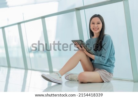 asian female collage young campus woman sitting on the mall floor using tablet browing surf data online social media with cheerful fun smiling,asian woman digital nomad sit on floor casual work online