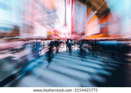 Abstract Motion blur of crowd of people and tourist walking across pedestrian crossing or crosswalk in Akihabara or Akiba, the commercial district well known for Anime, Manga, and Otaku goods.