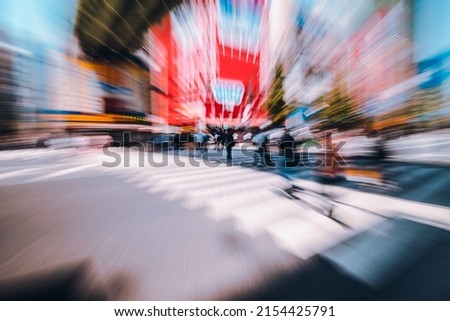 Abstract Motion blur of crowd of people and tourist walking across pedestrian crossing or crosswalk in Akihabara or Akiba, the commercial district well known for Anime, Manga, and Otaku goods.
