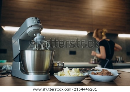 A beautiful white mixer with a metal cup stands in the modern kitchen Royalty-Free Stock Photo #2154446281