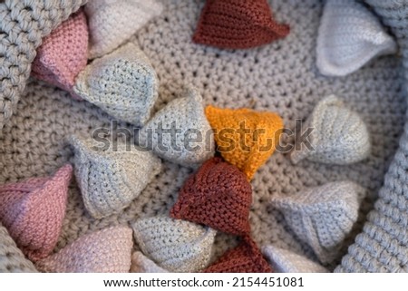 Pip Bags are small triangular crochet bags filled with beans, corn, stones or beads, with which you can play fun games and playfully teach and improve children's motor skills, also as a stress ball Royalty-Free Stock Photo #2154451081