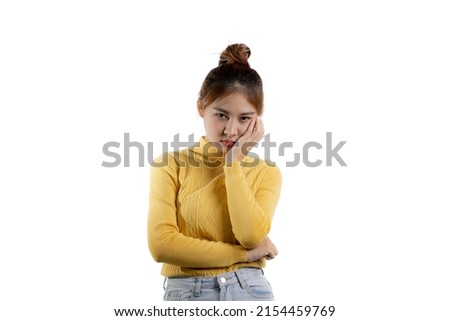 Portrait of a beautiful Asian woman in a yellow shirt standing with a tense face. portrait concept used for advertisement and signage, isolated over the blank background, copy space.