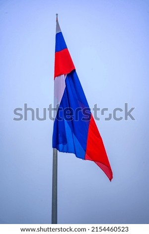 Slovenian country flag against the blue sky. Isolated.
