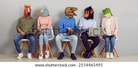 Funny people with animal faces talking while sitting in row in waiting room. Company employees or job applicants in silly masks sitting in line, chatting, using laptops, reading and discussing news