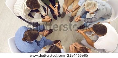 People talking in group therapy session or community meeting. Team of young and mature men and women sitting in circle and having serious discussion. High angle shot, top view banner background Royalty-Free Stock Photo #2154465685