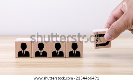 Customer retention concept. Inbound marketing strategy. Attracting potential customers. Hand puts wooden cubes with magnet attracts customer icons on beautiful grey background and copy space. Royalty-Free Stock Photo #2154466491