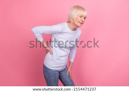 Profile side photo of mature woman hand on spine unwell sick sore medicine isolated over pink color background