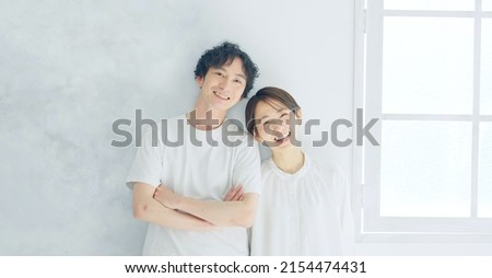 Asian couple in a white room. Refreshing lifestyle. Royalty-Free Stock Photo #2154474431