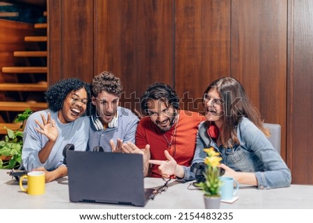 group of young influencers streaming using a laptop