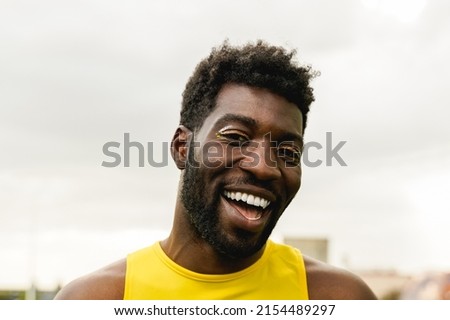 Gay African man wearing make up wearing make-up looking at camera outdoor - Queer and LGBT community concept Royalty-Free Stock Photo #2154489297