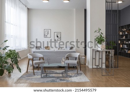 minimalist modern interior design huge bright apartment with an open plan in Scandinavian style in white, blue and dark blue colors with columns in the center. includes kitchen area, office and lounge Royalty-Free Stock Photo #2154495579