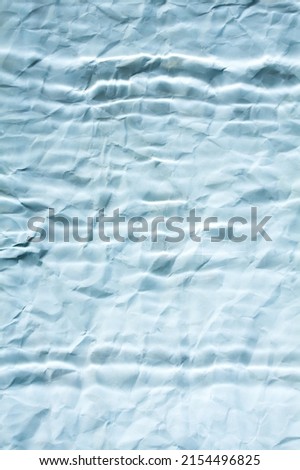 Abstract blue blurry paper background with parallel lines. Minimalist background in blue.