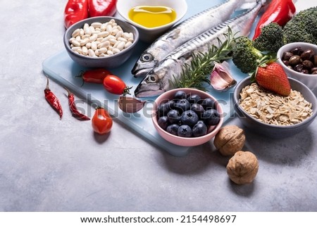 on the textured background, variety of Mediterranean healthy foods based on legumes, fish, vegetables, fruits and grains Royalty-Free Stock Photo #2154498697