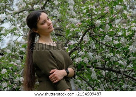 woman in a green dress, natural photo without makeup, spring photos and emotions