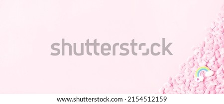 Blurred LGBT rainbow in clouds symbol.Valentine's Day background. Pink hearts on pastel pink background. Valentines day concept. Flat lay, top view, copy space