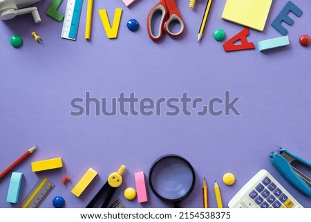 Different stationery on purple table background, flat lay. Space for text, back to school concept