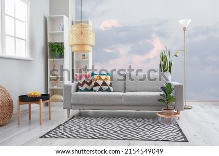 Interior of modern living room with comfortable sofa and painted wall