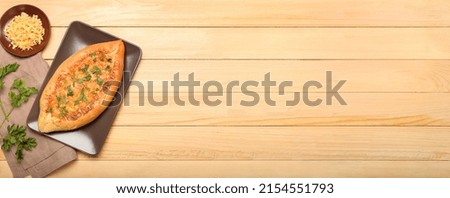 Tasty Turkish Pizza on wooden background with space for text