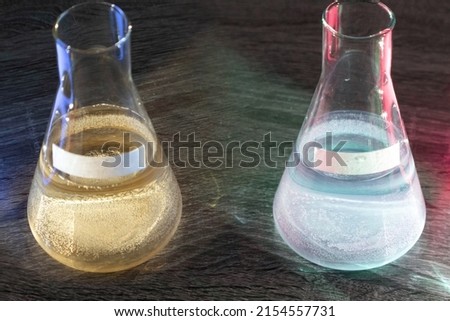 Two glass flasks with different acids (sulphurous, silicic, phosphoric). Place for text inscription chemical. The concept of a preview for a product card on the site. Royalty-Free Stock Photo #2154557731