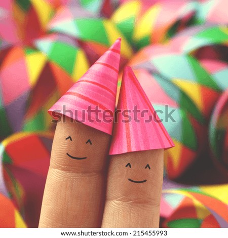 Funny party selfie of happy smiling couple with party hats drawn on fingers - retro style filtered square image