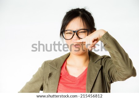 asian woman annoyed by some bad smell