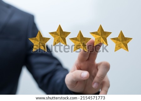 A businessman hand on blurred background using 3D rendering 5 stars icon