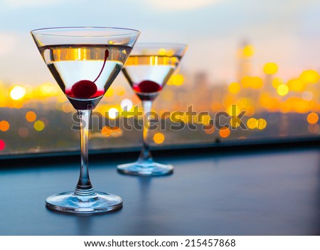 Cocktail glasses with city view. Royalty-Free Stock Photo #215457868
