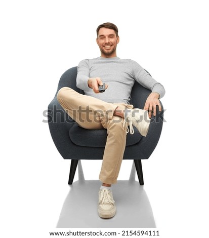 people and leisure concept - happy smiling man with tv remote control sitting in chair over white background Royalty-Free Stock Photo #2154594111