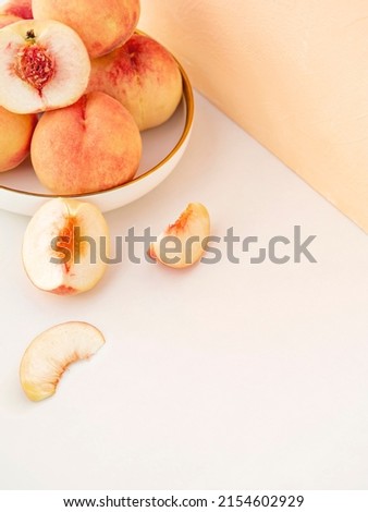 Summer fruit background. Composition with pale pink tender peaches. Ripe fresh organic fruit, vegan food. Harvest concept. Fruity summer diet concept. Copy space for text. Royalty-Free Stock Photo #2154602929