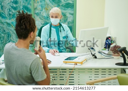 Young man during spirometry procedure in clinic Royalty-Free Stock Photo #2154613277